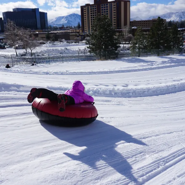 Girl snow tubing