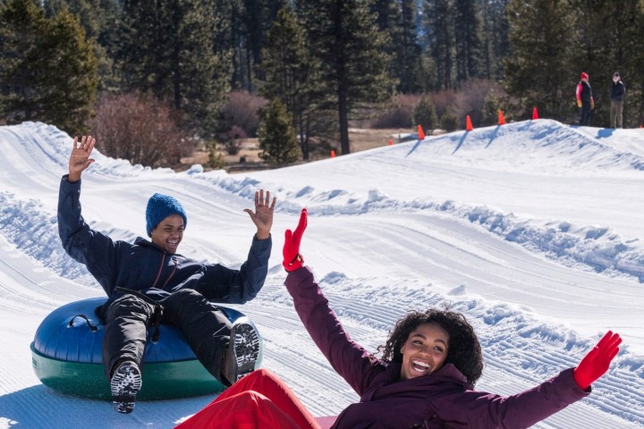 a group of people sitting in the snow