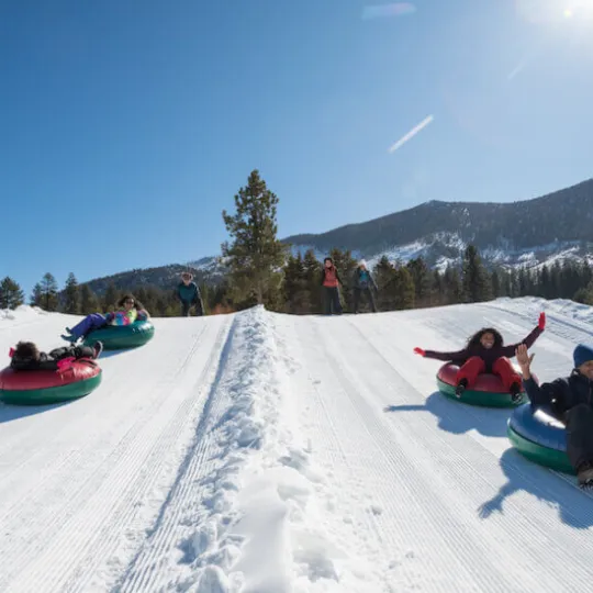 a man riding a snowboard down a snow covered slope