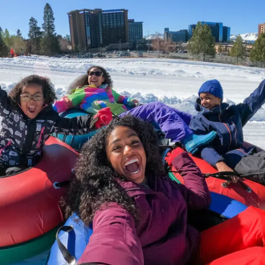 a group of people sitting in the snow
