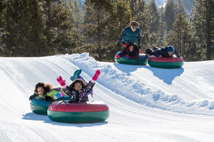 a group of people sitting in the snow