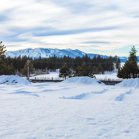 a man riding a snowboard down a snow covered slope