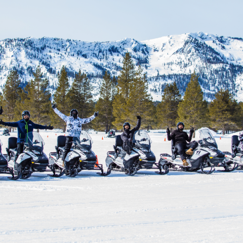 a group of people riding skis on top of a snow covered mountain
