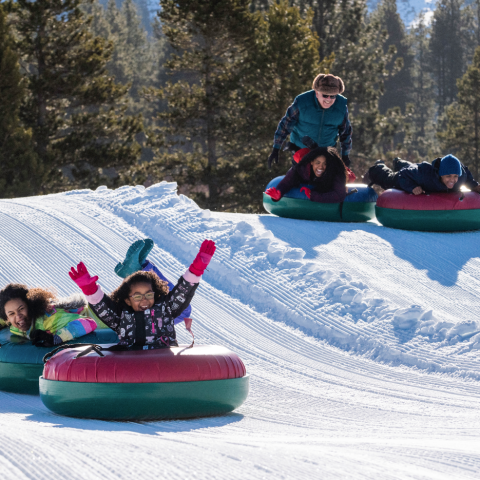 a small child is sitting in the snow