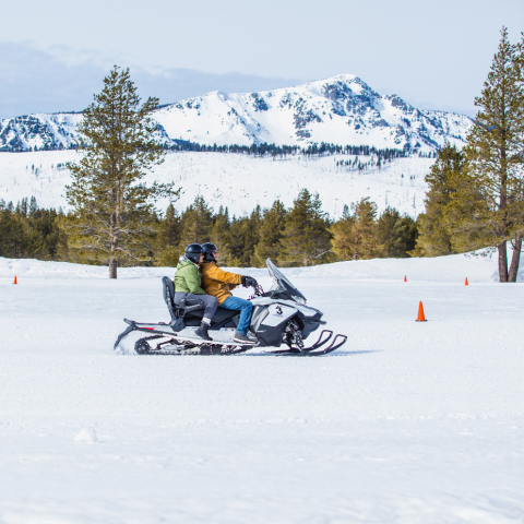a man riding skis down a snow covered slope