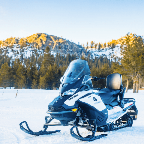 a person riding a motorcycle in the snow