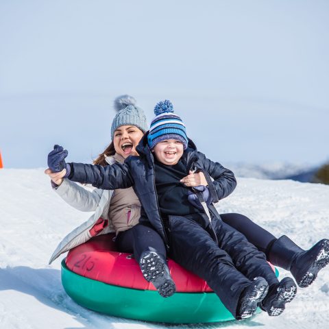 a person sitting on a snow board