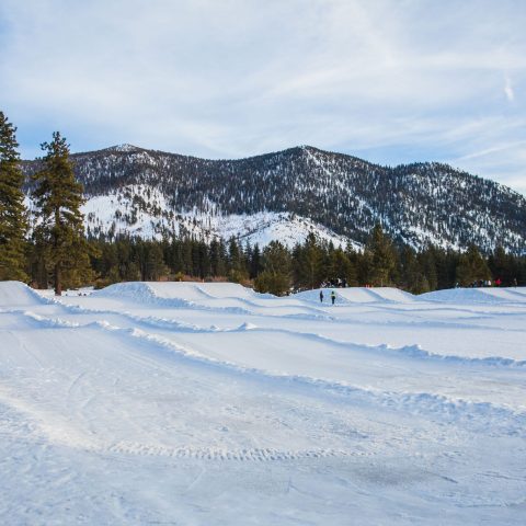 a man riding skis down a snow covered slope