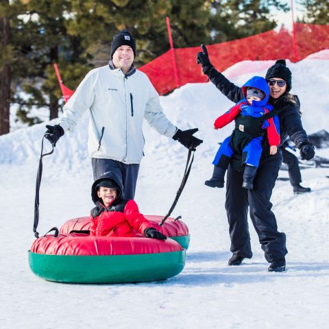 a group of people riding skis on top of a snow covered slope