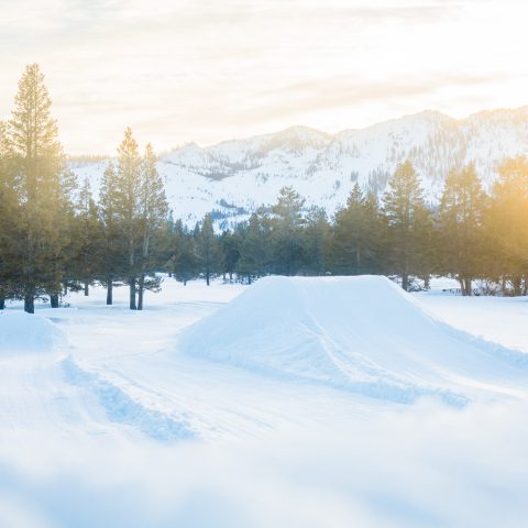a man riding on top of a snow covered slope