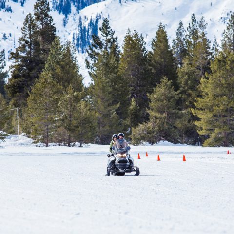 a man riding skis down a snow covered slope