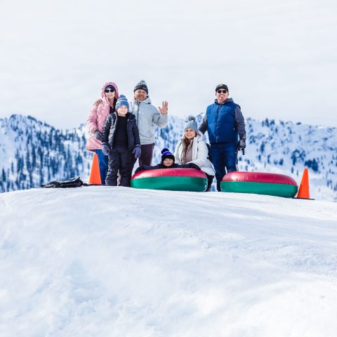 a group of people standing on top of a snow covered slope