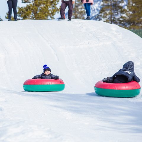 a group of people riding skis on top of a snow covered slope
