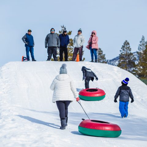 a group of people riding skis on top of a snow covered slope