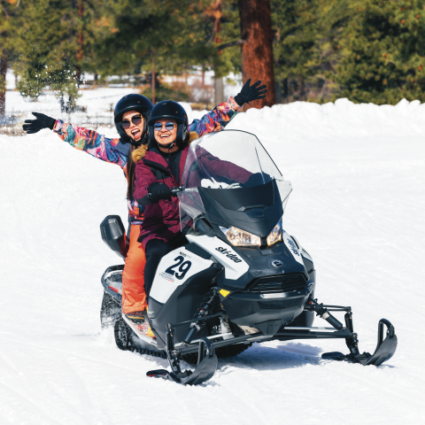 a person riding skis down a snow covered slope