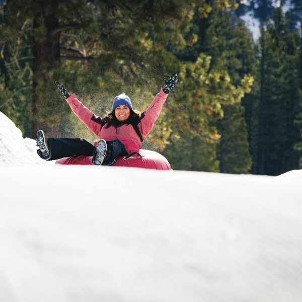 a man riding a snowboard down a snow covered slope