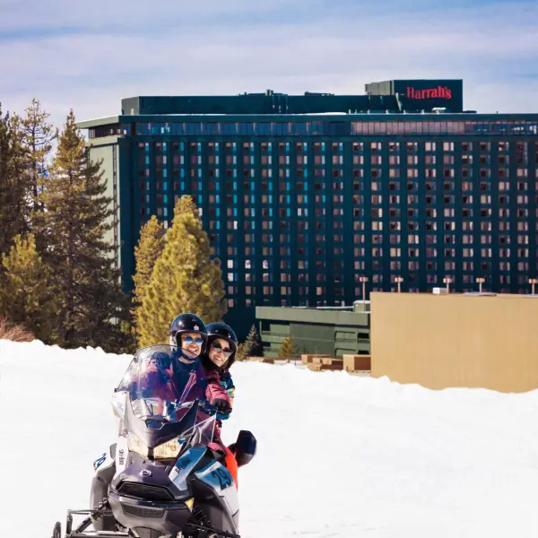 a man riding a snowboard down a snow covered slope